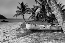 black and white photo of a dinghy on the beach at a native village in the Yasawa Islands, Fiji